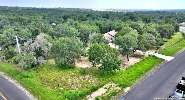 drone / aerial view with a wooded view