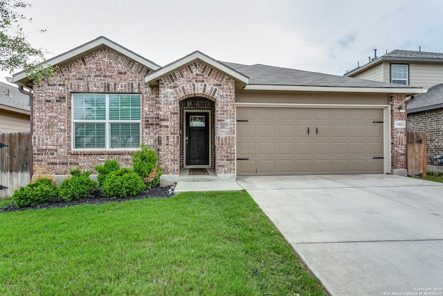 view of front of home featuring brick siding, a front lawn, a garage, and concrete driveway