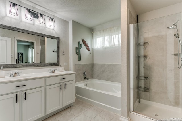 full bathroom with tile patterned flooring, a garden tub, a sink, and a stall shower