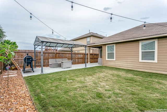 view of yard featuring a gazebo, an outdoor hangout area, a patio area, and a fenced backyard