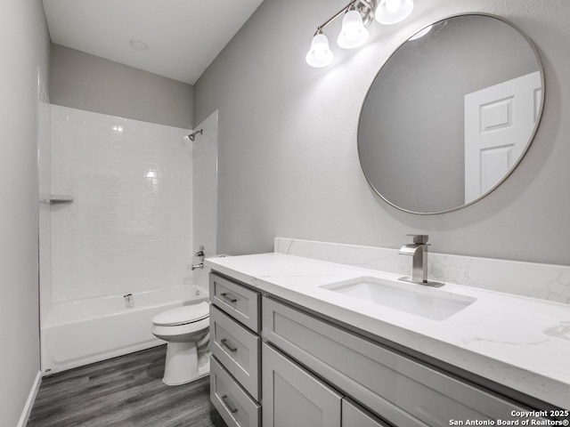 bathroom with toilet, bathtub / shower combination, vanity, and wood finished floors