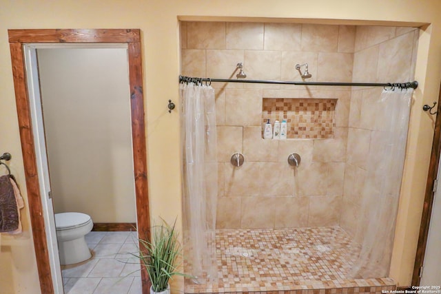 745 County Road 2645, Moore, TX 78057 - bathroom with toilet, baseboards, tile patterned floors, and a tile shower