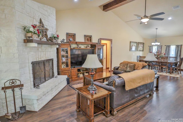 745 County Road 2645, Moore, TX 78057 - living room with wood finished floors, visible vents, a ceiling fan, beamed ceiling, and a fireplace