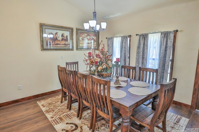 745 County Road 2645, Moore, TX 78057 - dining area featuring baseboards, wood finished floors, and an inviting chandelier