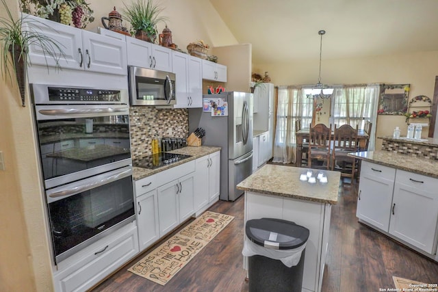 745 County Road 2645, Moore, TX 78057 - kitchen featuring white cabinets, an inviting chandelier, stainless steel appliances, dark wood finished floors, and backsplash