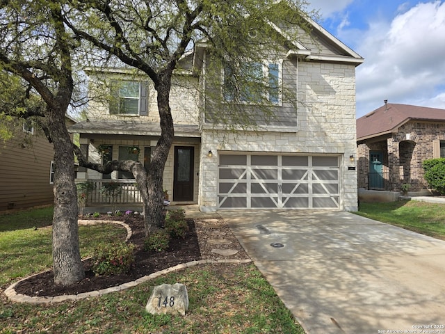 traditional-style house featuring an attached garage, stone siding, and driveway