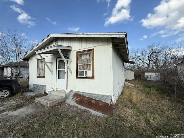 view of front facade with cooling unit and entry steps