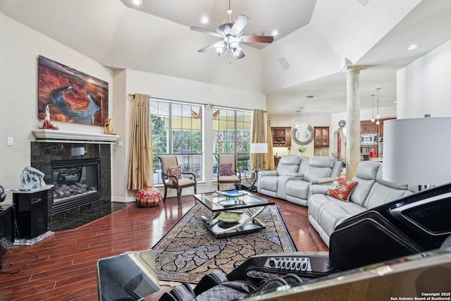20646 Wahl, Garden Ridge, TX 78266 - living area featuring decorative columns, ceiling fan, wood finished floors, a fireplace, and high vaulted ceiling