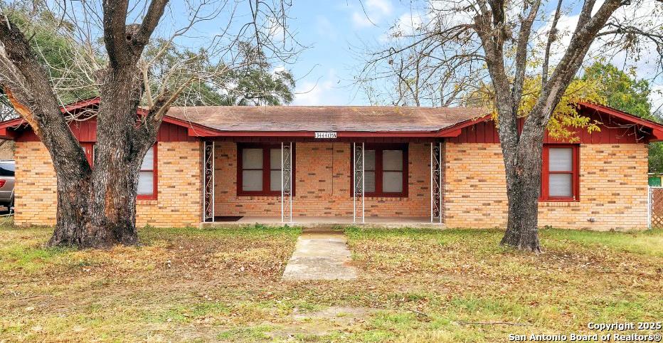 13444 Interstate 35, Moore, TX 78057 - ranch-style home featuring covered porch and brick siding