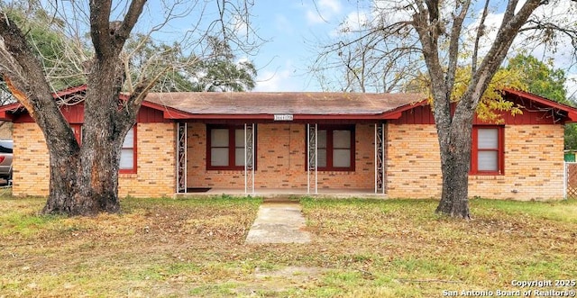 13444 Interstate 35, Moore, TX 78057 - ranch-style home featuring covered porch and brick siding