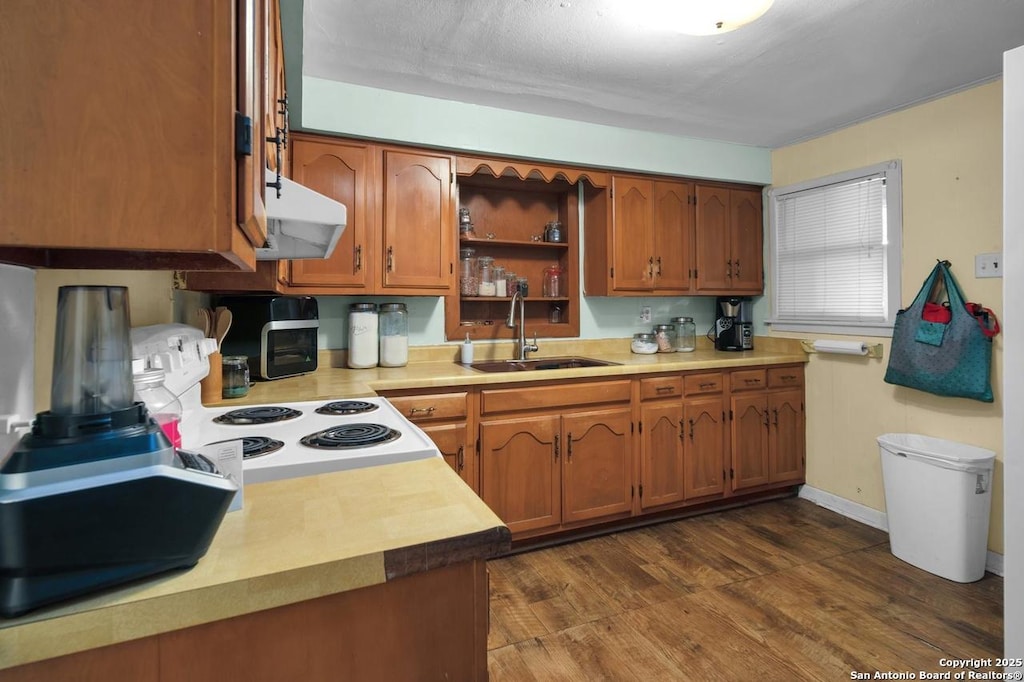 13444 Interstate 35, Moore, TX 78057 - kitchen with open shelves, a sink, brown cabinets, electric range oven, and dark wood-type flooring