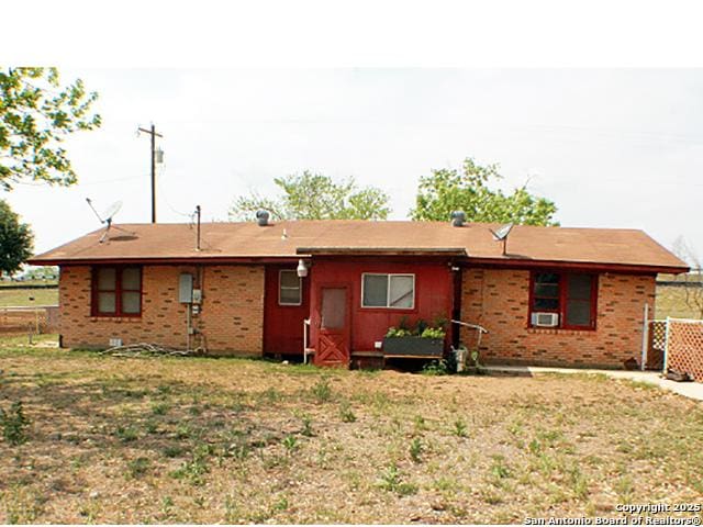 13444 Interstate 35, Moore, TX 78057 - rear view of house with brick siding and fence
