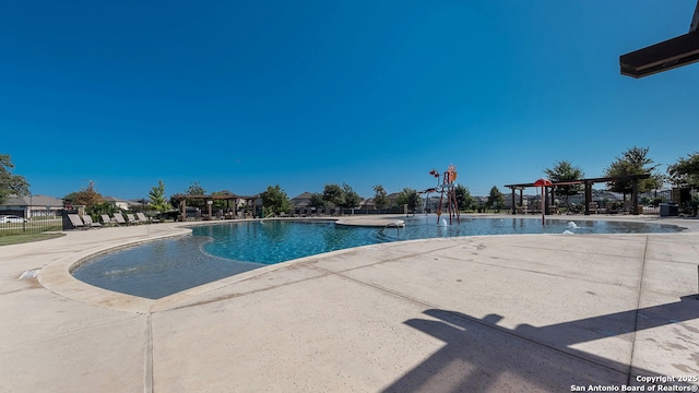 pool featuring a patio and fence
