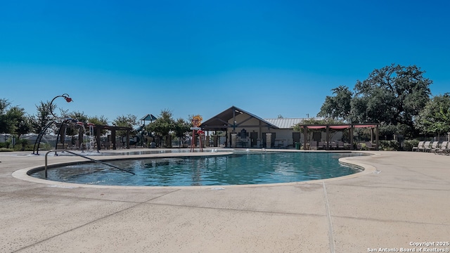 community pool with a patio and fence