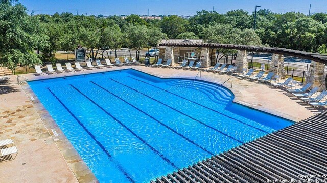 pool featuring a patio area and fence