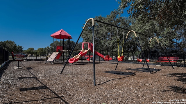 community jungle gym featuring fence