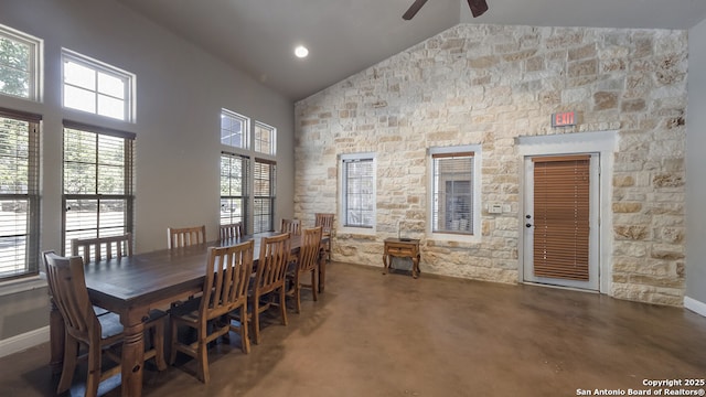 dining space with high vaulted ceiling, baseboards, and a ceiling fan