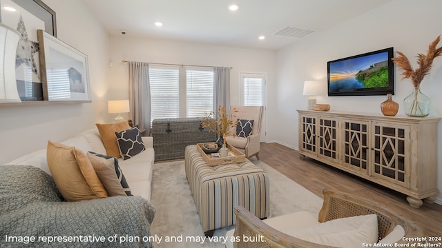 living room featuring recessed lighting, wood finished floors, and visible vents