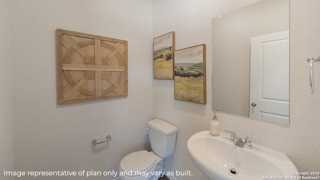 half bath featuring a sink and toilet