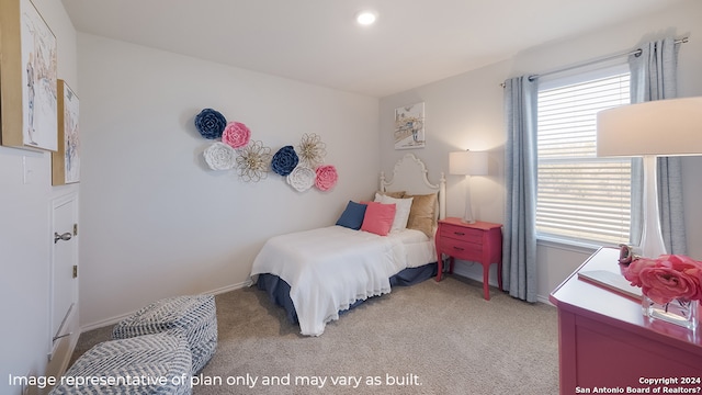 bedroom with light carpet, baseboards, and multiple windows