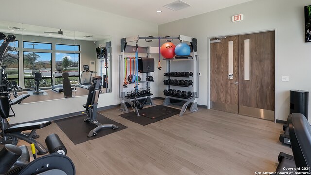 workout area featuring wood finished floors, baseboards, a ceiling fan, and recessed lighting