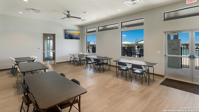 dining space featuring french doors, ceiling fan, light wood finished floors, and visible vents