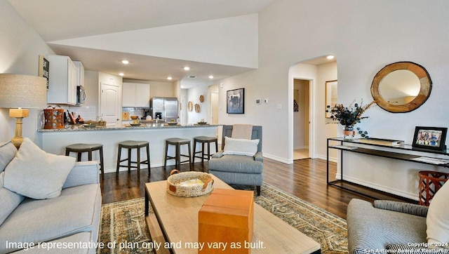 living room with recessed lighting, arched walkways, high vaulted ceiling, and dark wood-style floors