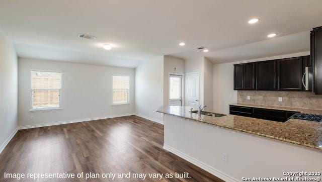 14614 Clay Ridge Run, San Antonio, TX 78253 - kitchen with a sink, light stone countertops, healthy amount of natural light, backsplash, and recessed lighting