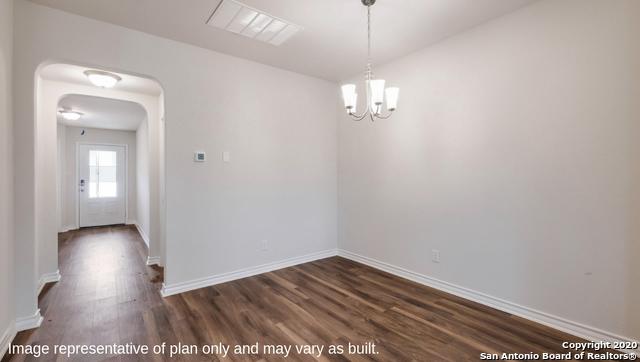 14614 Clay Ridge Run, San Antonio, TX 78253 - unfurnished dining area with dark wood finished floors, baseboards, arched walkways, and a chandelier