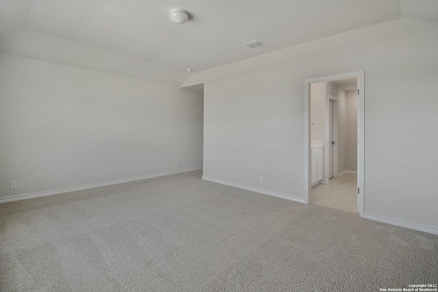 12127 Jasper Strm, San Antonio, TX 78245 - spare room with lofted ceiling, light carpet, and baseboards