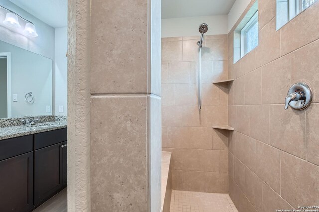 5680 Jasmine Spur, Bulverde, TX 78163 - bathroom featuring tiled shower and vanity