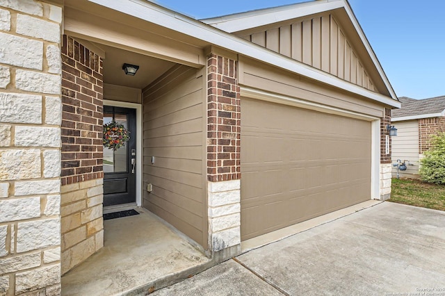 5680 Jasmine Spur, Bulverde, TX 78163 - property entrance with board and batten siding, concrete driveway, a garage, and brick siding