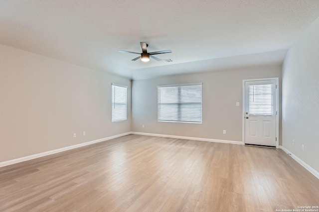 5680 Jasmine Spur, Bulverde, TX 78163 - unfurnished room with a ceiling fan, plenty of natural light, light wood-style floors, and baseboards