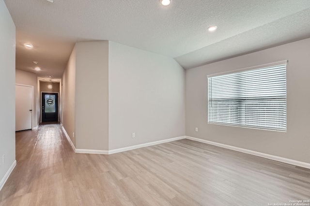 5680 Jasmine Spur, Bulverde, TX 78163 - spare room with light wood-style flooring, baseboards, a textured ceiling, and recessed lighting