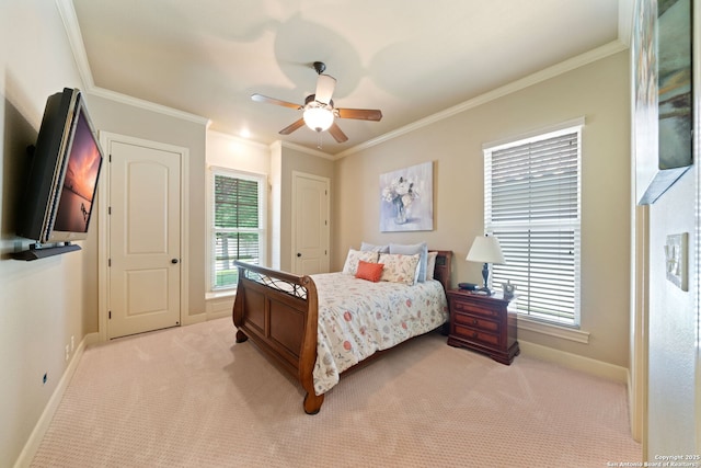 bedroom with light colored carpet, a ceiling fan, baseboards, and ornamental molding