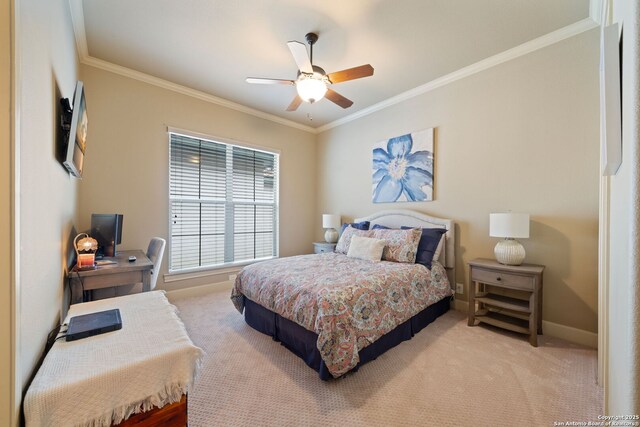 carpeted bedroom featuring a ceiling fan, baseboards, and ornamental molding