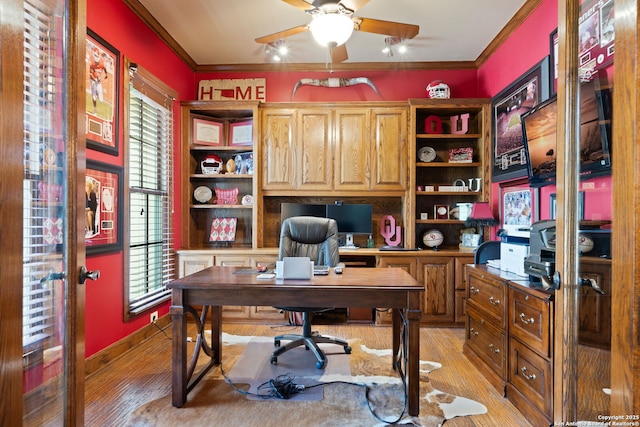 office area with light wood-style flooring, ornamental molding, and a ceiling fan