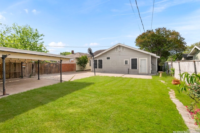 back of property with a lawn, a fenced backyard, and a patio