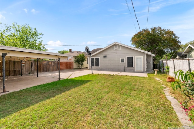 rear view of house with a patio area, a lawn, and a fenced backyard