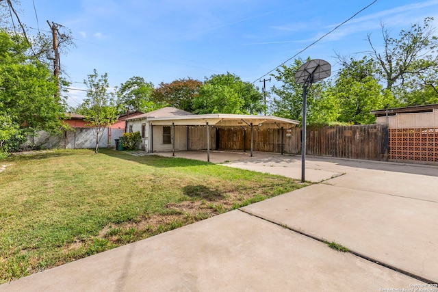 exterior space featuring fence and a carport