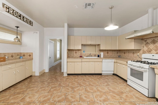 kitchen featuring light countertops, visible vents, decorative backsplash, and white appliances