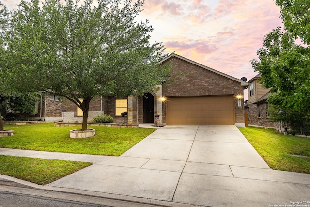 single story home featuring an attached garage, brick siding, a front yard, and concrete driveway