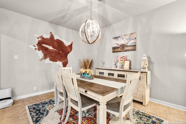 dining area featuring light tile patterned flooring, baseboards, and a notable chandelier