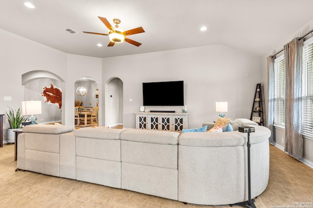 living room with arched walkways, visible vents, recessed lighting, lofted ceiling, and a ceiling fan