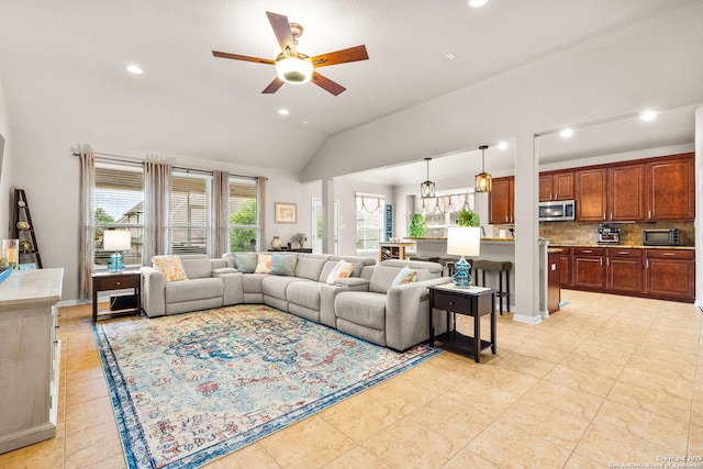 living room with lofted ceiling, a ceiling fan, and recessed lighting
