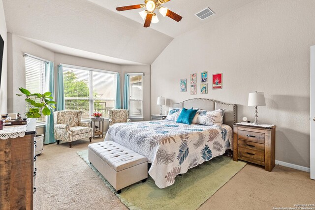 carpeted bedroom featuring lofted ceiling, visible vents, a ceiling fan, and baseboards