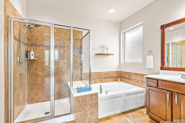 bathroom with a bath, vanity, and a stall shower