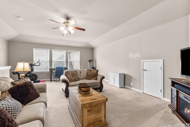 living room with lofted ceiling, visible vents, a textured ceiling, light colored carpet, and ceiling fan