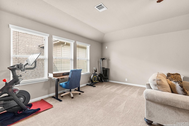 home office with vaulted ceiling, visible vents, baseboards, and light carpet
