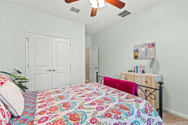carpeted bedroom with a closet, visible vents, baseboards, and ceiling fan